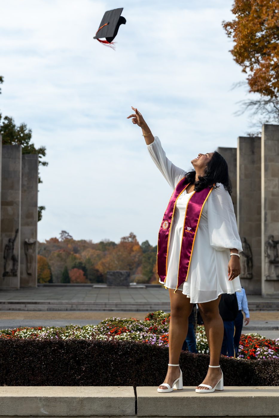Graduate tossing her cap into the sky