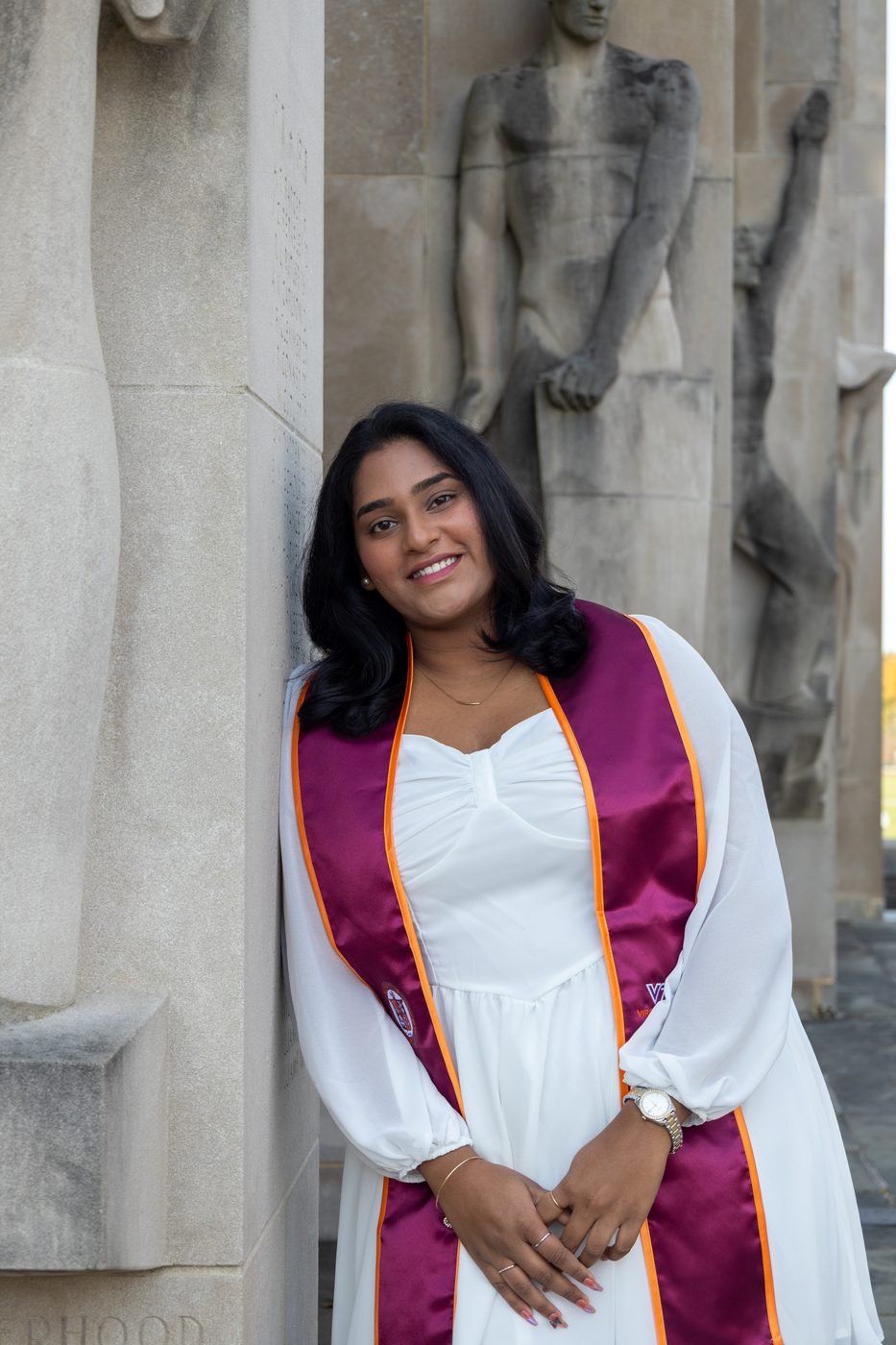 Graduate portrait among stone sculptures