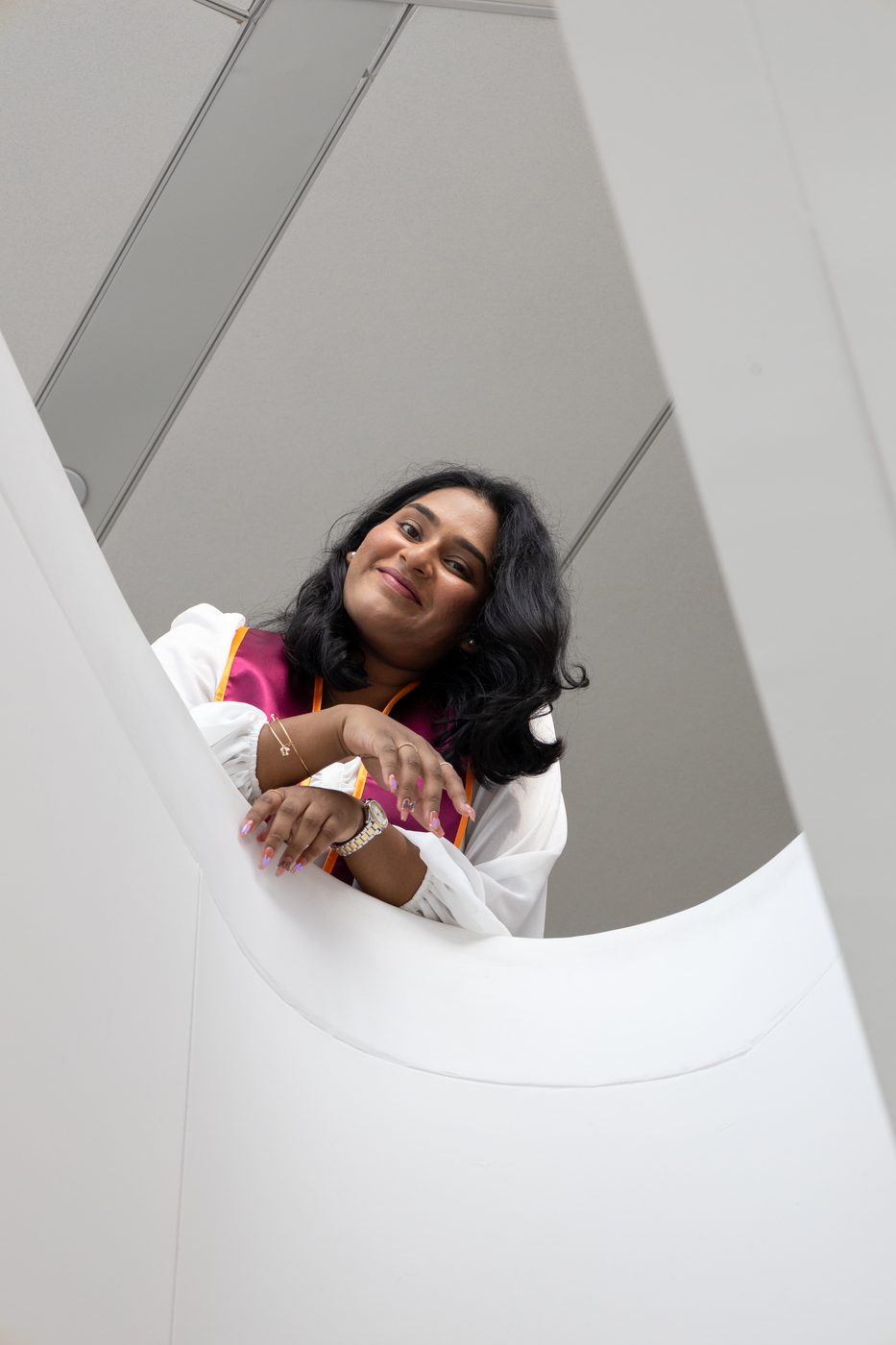 Graduate on spiral staircase