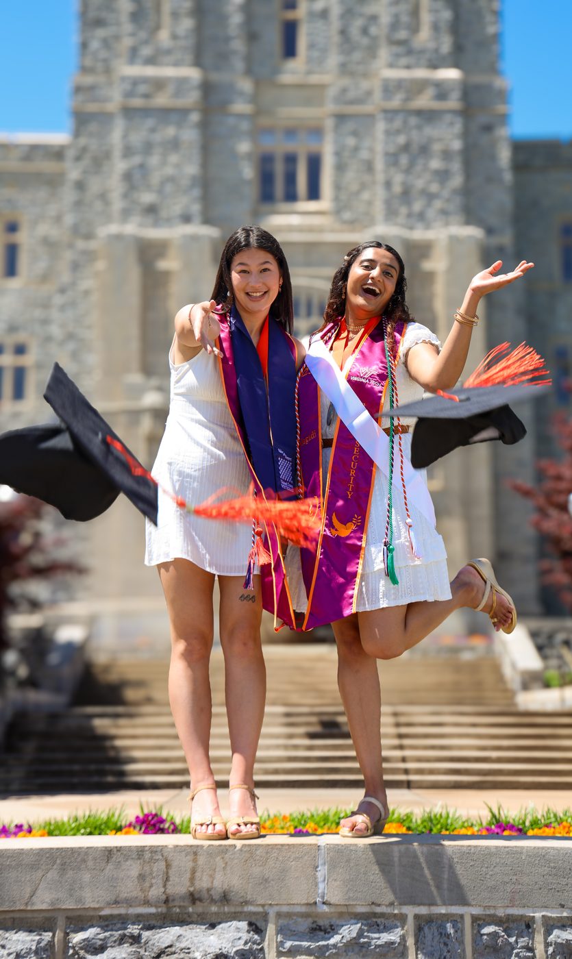 Two graduates celebrating together